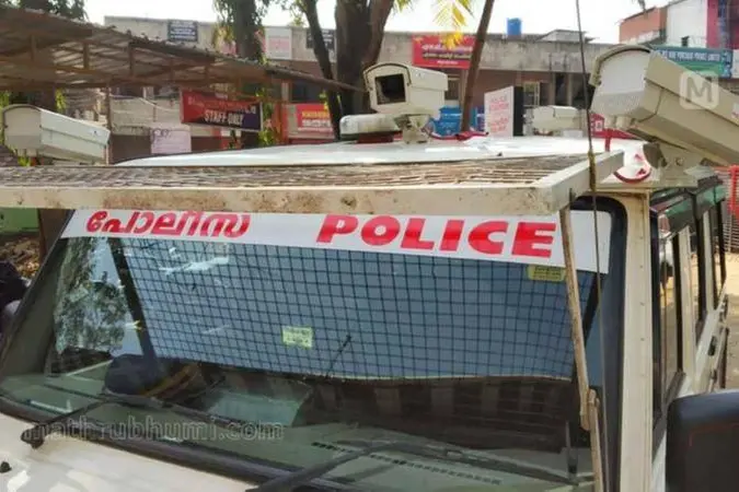 "Kerala political protest related to Paradipattu case with people holding placards and banners in front of the Thiruvananthapuram cyber police station"