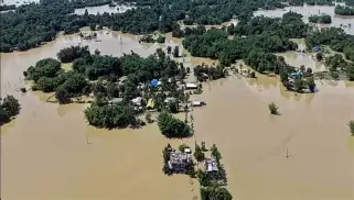 Assam flood victims being rescued by rescue teams in a boat