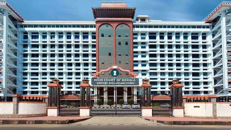 Kerala High Court building view representing the teacher suspension stay order.