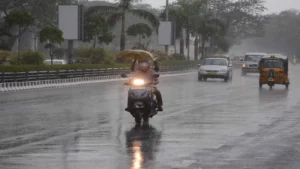 Heavy rain falling in Kerala streets with dark clouds.