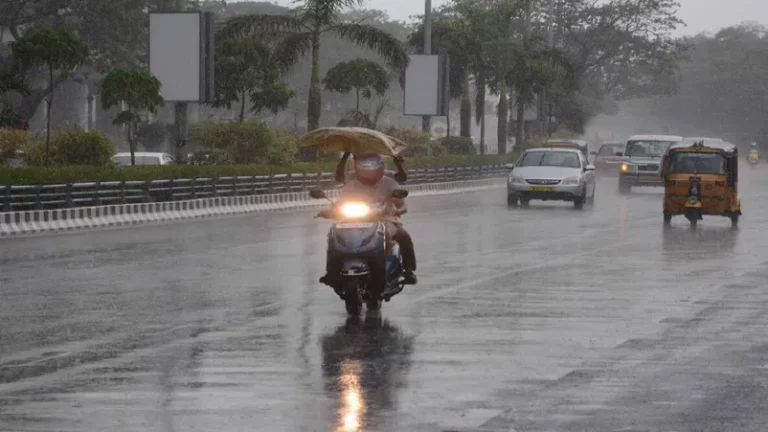 Heavy rain falling in Kerala streets with dark clouds.